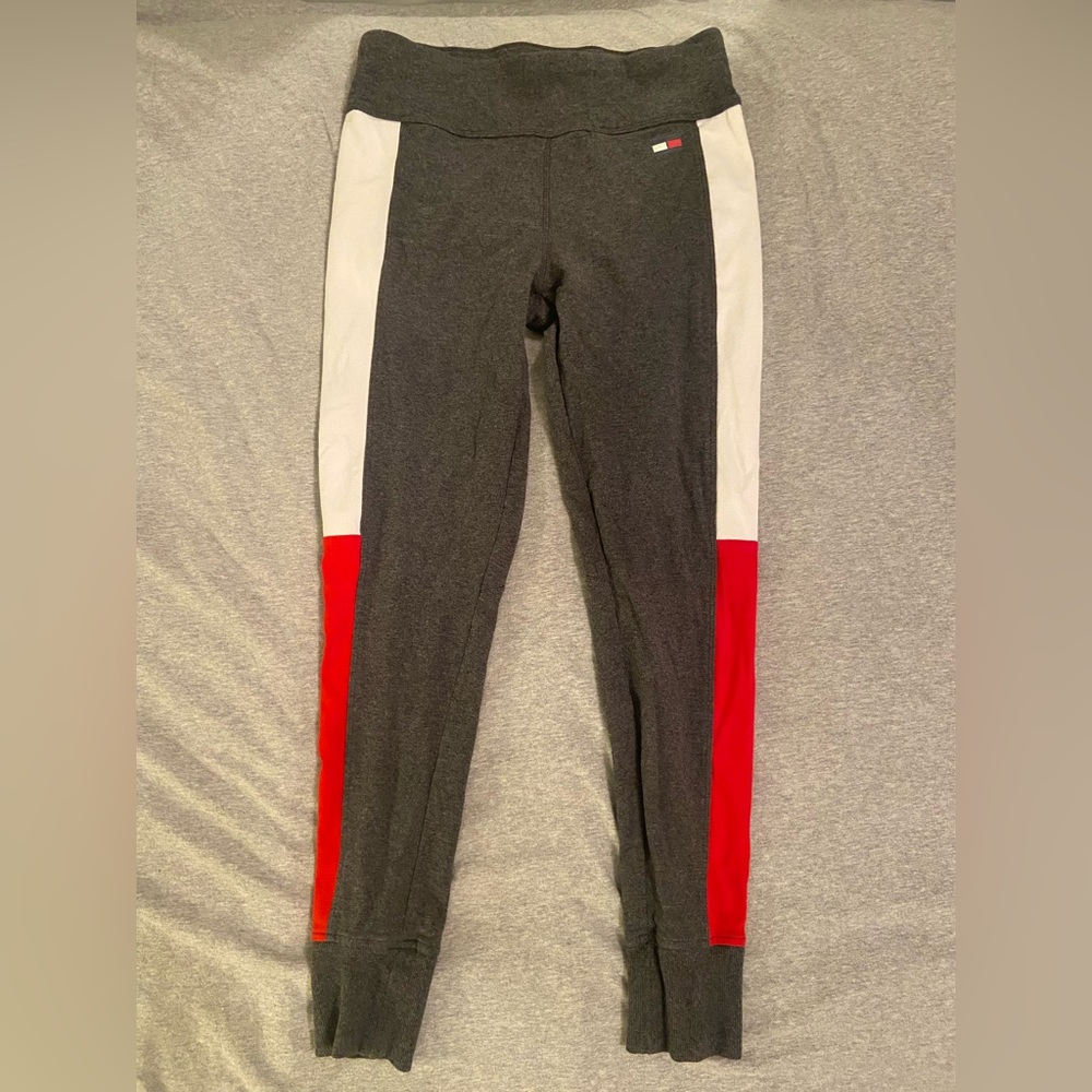 charcoal gray leggings with a white and red stripe down the side